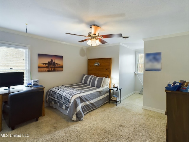 carpeted bedroom with ceiling fan and ornamental molding