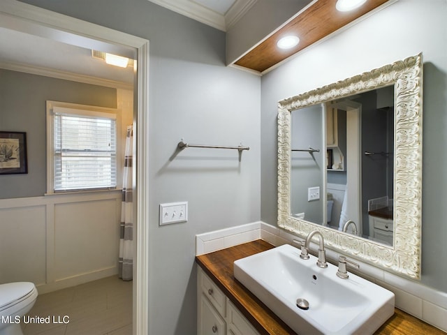 bathroom featuring toilet, crown molding, tile patterned floors, and vanity