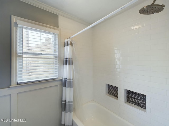 bathroom with crown molding and shower / bathtub combination with curtain