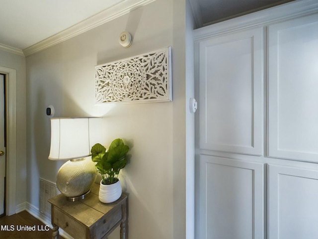 interior space with hardwood / wood-style flooring and ornamental molding