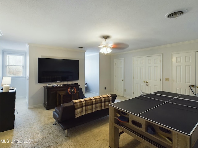 game room featuring light carpet, ceiling fan, and crown molding