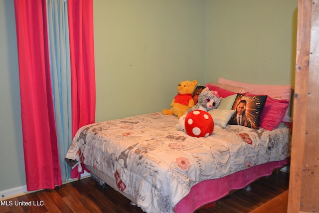 bedroom featuring wood finished floors