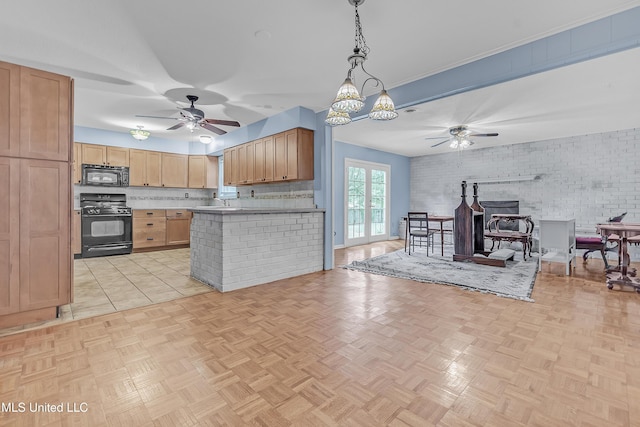 6830 Embassy Cir, Horn Lake, MS 38637 - kitchen with black appliances, open floor plan, a ceiling fan, pendant lighting, and a wood stove