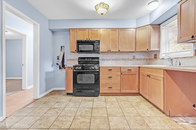 6830 Embassy Cir, Horn Lake, MS 38637 - kitchen featuring black appliances, tasteful backsplash, light countertops, light brown cabinets, and a sink
