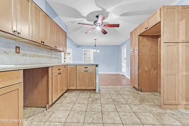 6830 Embassy Cir, Horn Lake, MS 38637 - kitchen featuring a ceiling fan, a peninsula, light countertops, tasteful backsplash, and light brown cabinetry