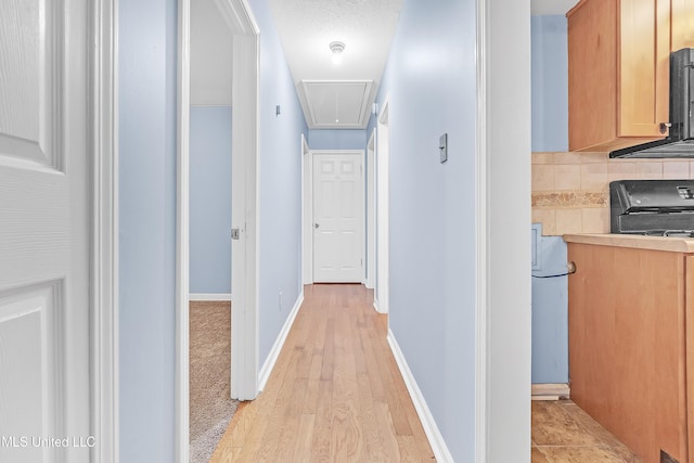 6830 Embassy Cir, Horn Lake, MS 38637 - hall with attic access, light wood finished floors, and baseboards