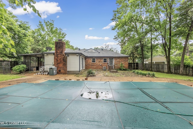 6830 Embassy Cir, Horn Lake, MS 38637 - back of house with brick siding, a sunroom, a fenced backyard, and a chimney