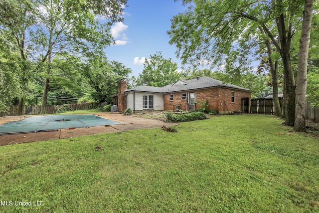 6830 Embassy Cir, Horn Lake, MS 38637 - rear view of house with brick siding, a chimney, and a patio area