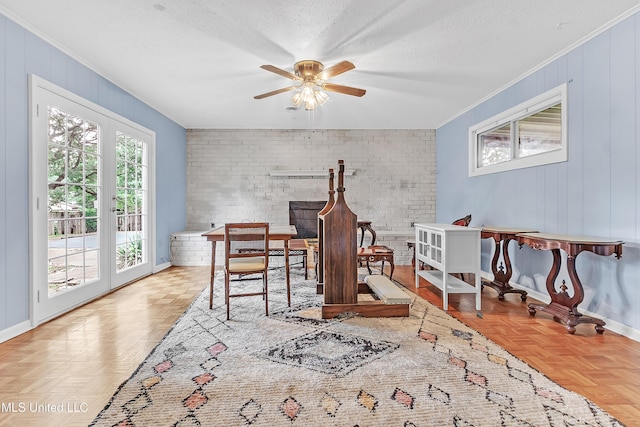 6830 Embassy Cir, Horn Lake, MS 38637 - dining area featuring crown molding, baseboards, a ceiling fan, brick wall, and a textured ceiling