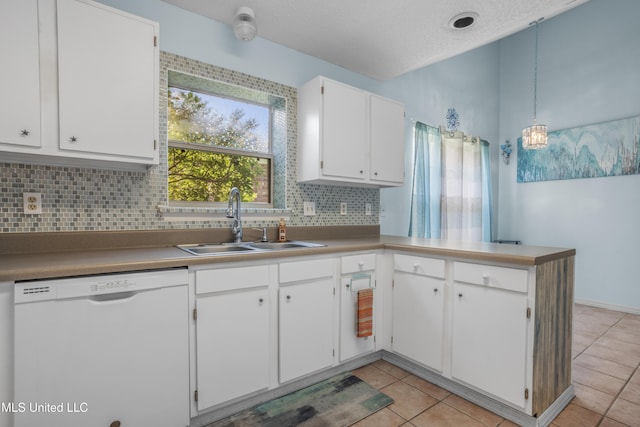 172 Briarfield Ave, Biloxi, MS 39531 - kitchen with white dishwasher, decorative backsplash, white cabinetry, a peninsula, and light tile patterned floors