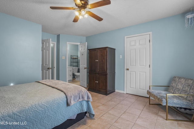 172 Briarfield Ave, Biloxi, MS 39531 - bedroom with light tile patterned floors, ensuite bath, ceiling fan, and a textured ceiling