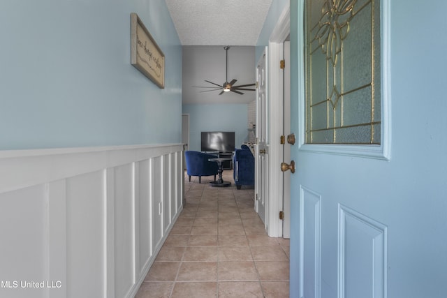 172 Briarfield Ave, Biloxi, MS 39531 - hallway with light tile patterned floors, a textured ceiling, and a desk