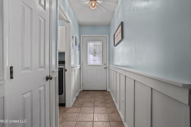 172 Briarfield Ave, Biloxi, MS 39531 - doorway with a decorative wall, a wainscoted wall, a textured ceiling, and washer / dryer
