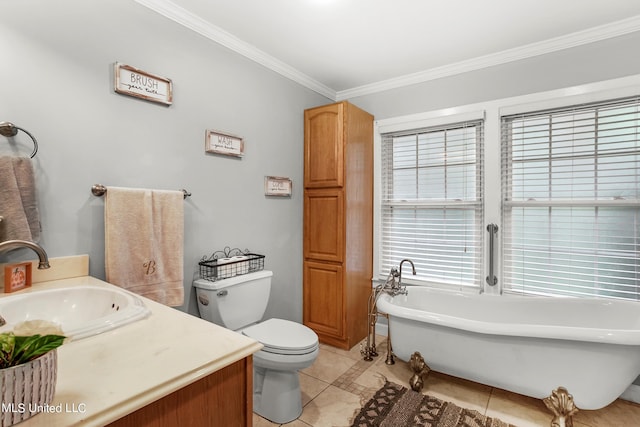 bathroom with toilet, a washtub, vanity, crown molding, and tile patterned floors