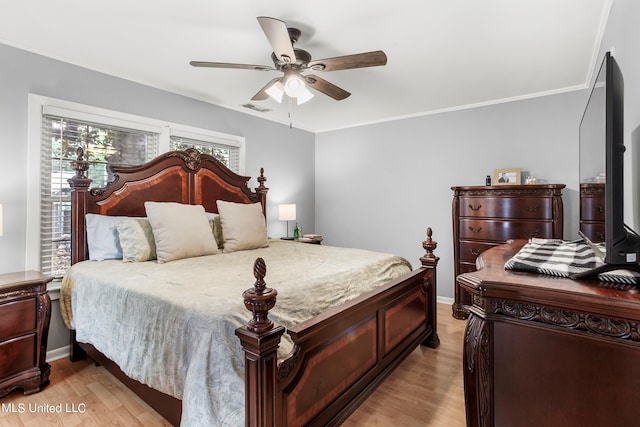 bedroom with ceiling fan, crown molding, and light wood-type flooring