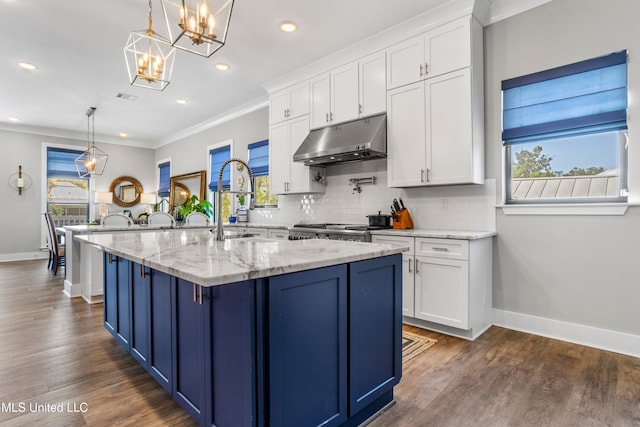 kitchen featuring a wealth of natural light, white cabinets, and pendant lighting