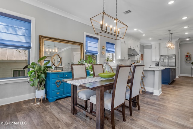 dining space featuring light hardwood / wood-style flooring and crown molding