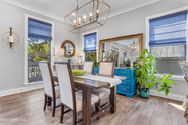 dining space featuring ornamental molding, a healthy amount of sunlight, and light wood-type flooring