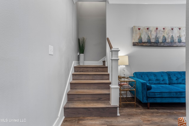 stairs featuring wood-type flooring