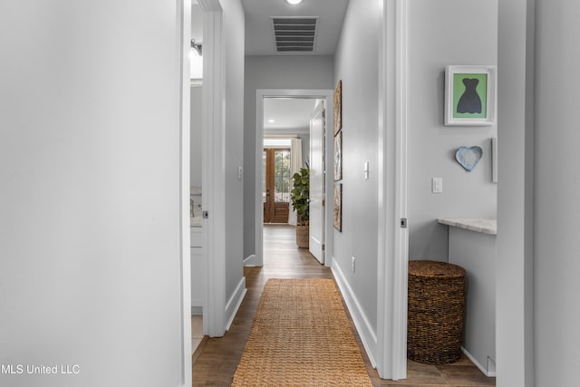 corridor with dark hardwood / wood-style flooring