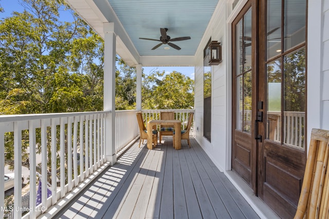 wooden deck featuring ceiling fan