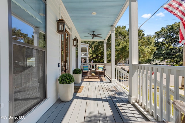 wooden deck with ceiling fan and a porch