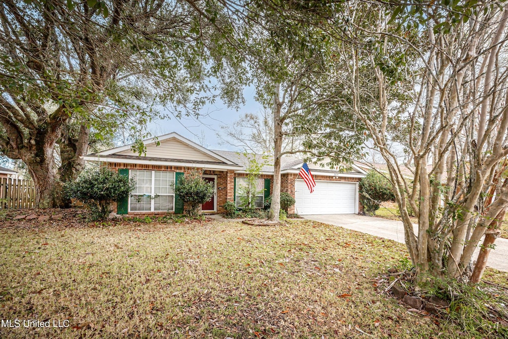 ranch-style house featuring a garage and a front lawn