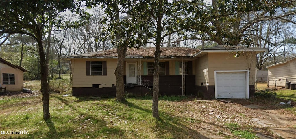 ranch-style house featuring a garage, a front yard, driveway, and a porch