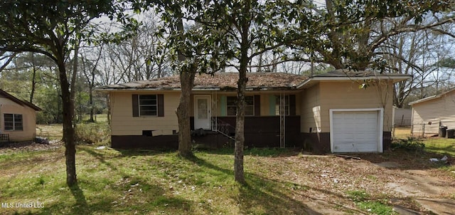 ranch-style house featuring a garage, a front yard, driveway, and a porch