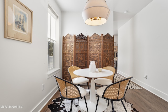 dining room with baseboards and wood finished floors