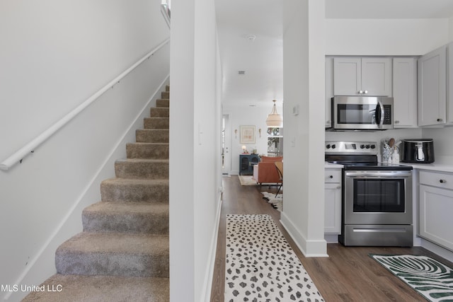 staircase with wood finished floors