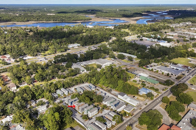 birds eye view of property with a water view, a residential view, and a view of trees