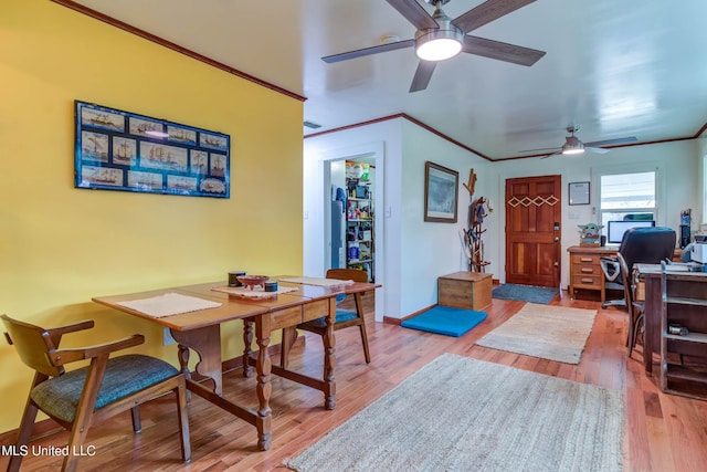 dining space featuring crown molding, ceiling fan, and wood-type flooring