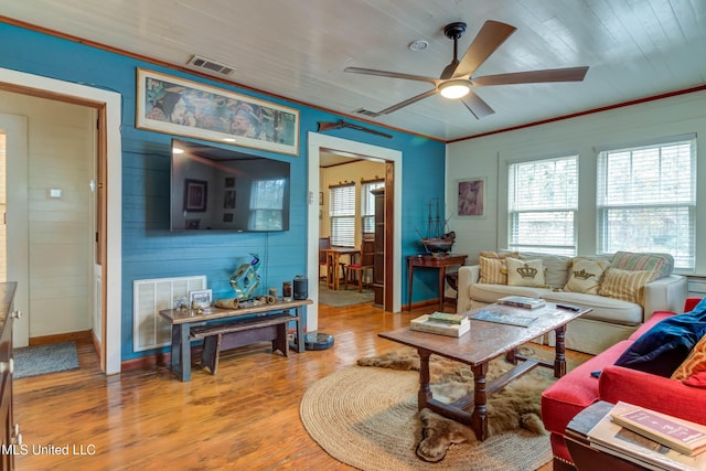 living room featuring crown molding, wood ceiling, wood-type flooring, and ceiling fan