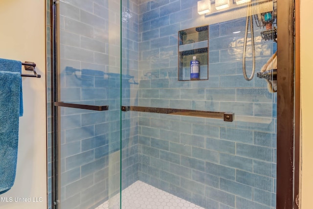 bathroom with a shower with shower door