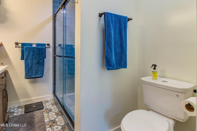 bathroom with walk in shower, vanity, and toilet