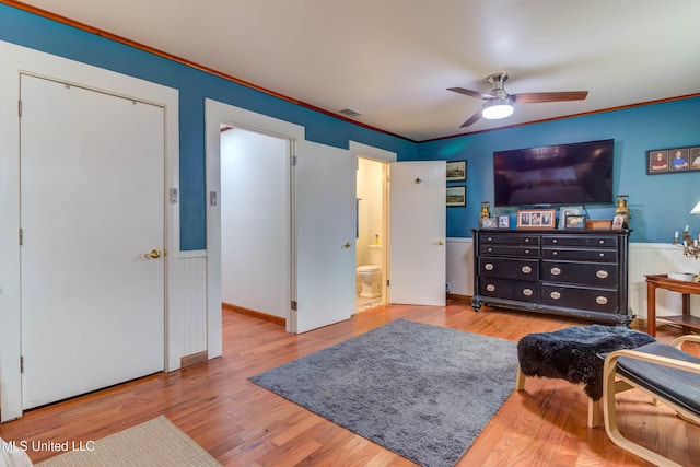 living room with wood-type flooring, ceiling fan, and crown molding