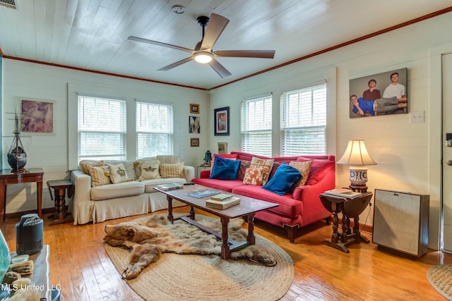 living room featuring ceiling fan, ornamental molding, plenty of natural light, and light wood-type flooring