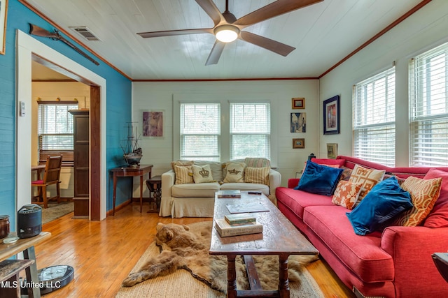 living room featuring crown molding, ceiling fan, plenty of natural light, and light wood-type flooring