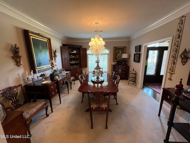 dining area with crown molding, light colored carpet, an inviting chandelier, and plenty of natural light