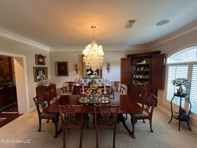 carpeted dining room featuring crown molding and an inviting chandelier