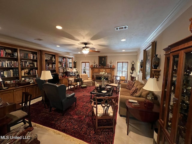 carpeted living room featuring crown molding, a textured ceiling, a fireplace, and ceiling fan