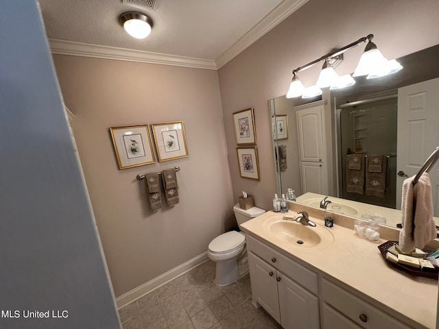 bathroom with vanity, ornamental molding, toilet, and walk in shower