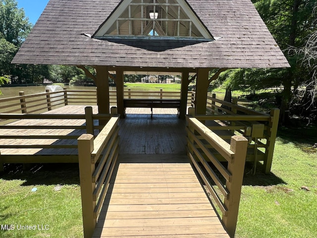 exterior space featuring a wooden deck and a lawn