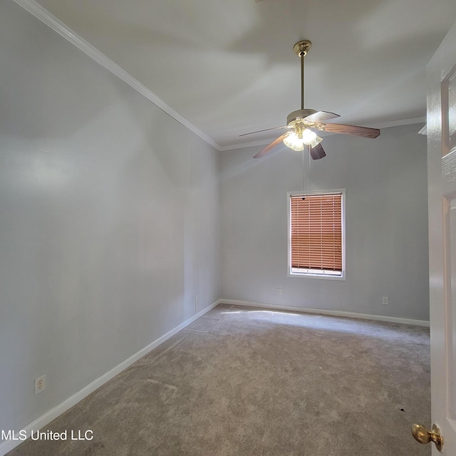 spare room with crown molding, baseboards, and a ceiling fan