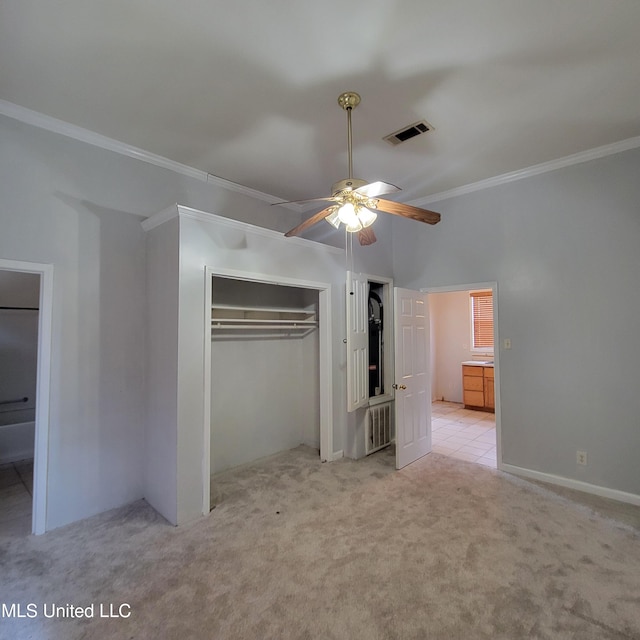 unfurnished bedroom featuring a closet, ornamental molding, radiator heating unit, visible vents, and light colored carpet