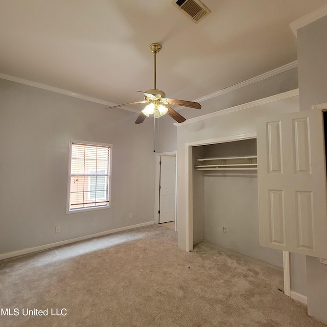 unfurnished bedroom with a closet, carpet floors, visible vents, baseboards, and ornamental molding