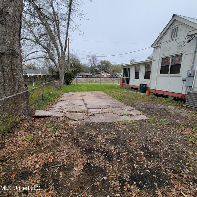 view of yard with cooling unit, a patio, and fence