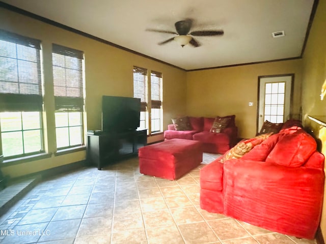 living room with crown molding, ceiling fan, and light tile patterned floors