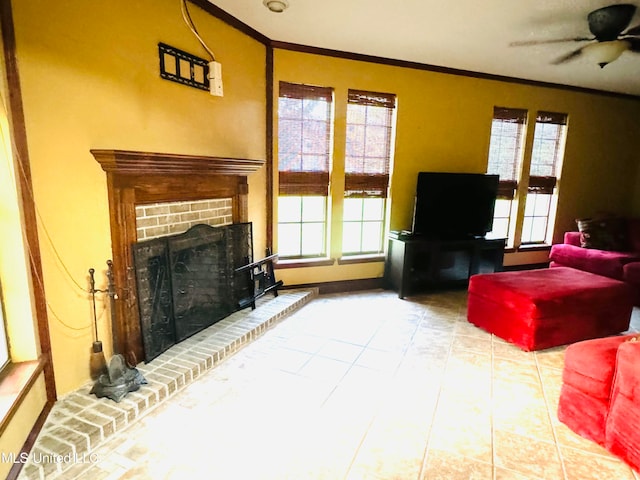 tiled living room with crown molding, a brick fireplace, and ceiling fan